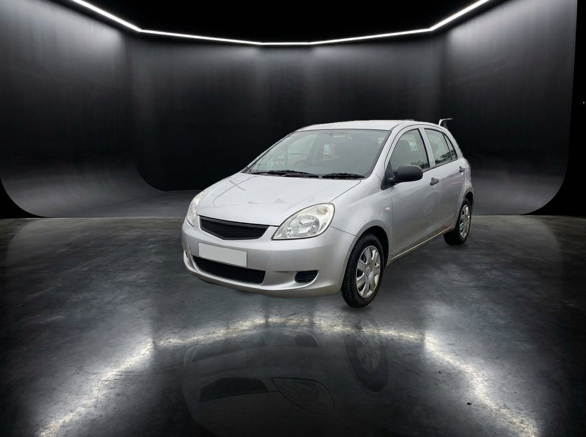 The silver hatchback in a dark studio